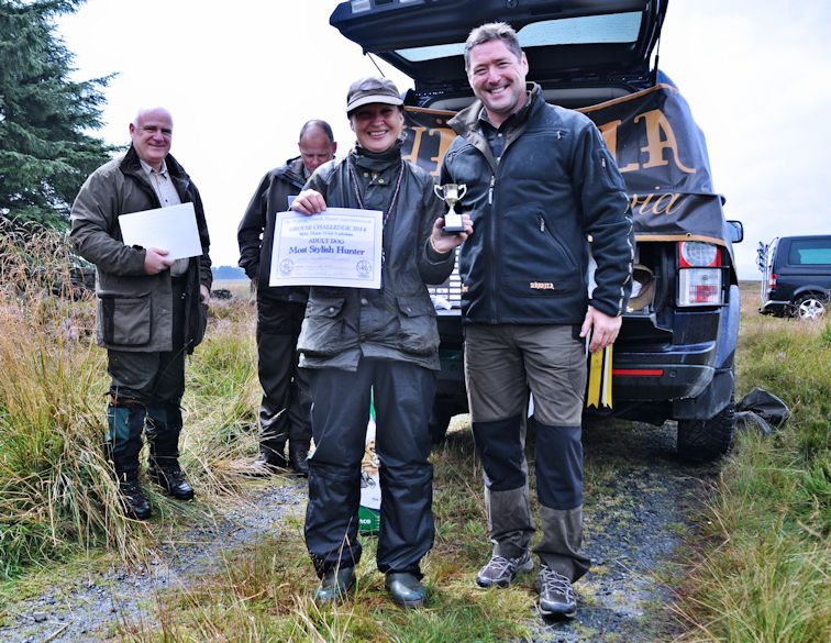 
 Jo Wilson, WVPA Grouse Challenge presented with the Hunting Award by Ewen Steel of Harkila, judges Iain Marshalsay and Andy Cullen MBE looking on